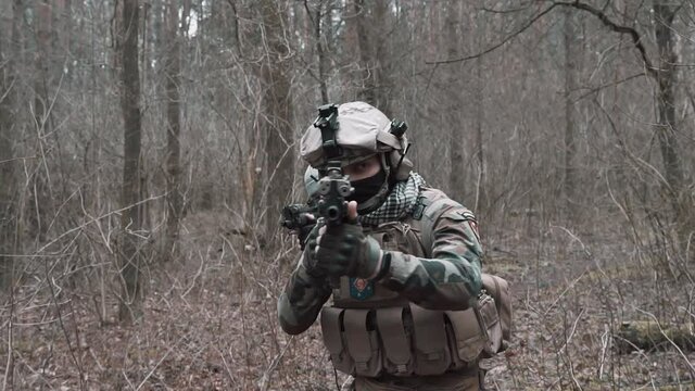 soldiers move through the forest in slow motion