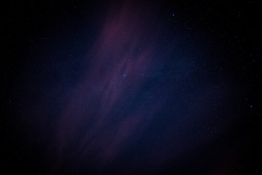 Night sky stars extreme detail background with cloud, a faint outline of the Milky Way and blue, pink and purple colours
