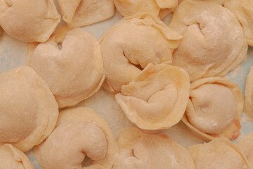 Homemade dumplings are put together on a Board in the kitchen