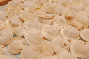 Homemade dumplings are put together on a Board in the kitchen