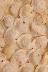 Homemade dumplings are put together on a Board in the kitchen