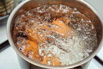 Cooking chicken eggs in a small saucepan