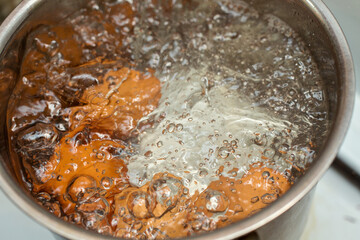 Cooking chicken eggs in a small saucepan