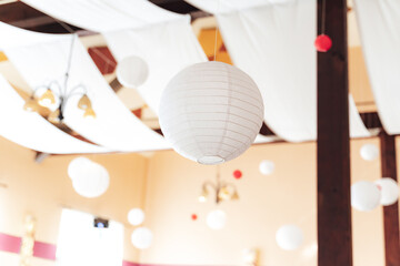 Party room decoration. Big paper lanterns hanging from ceiling. Celebration, wedding, birthday...