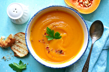 Delicious autumn pumpkin soup. Top view with copy space.