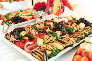 Fruit and vegetable buffet table and of glass of red beverage. Celebration, birthday, party, wedding concept.