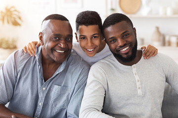 Joyful african son, dad and grandfather posing for family picture at home - Powered by Adobe