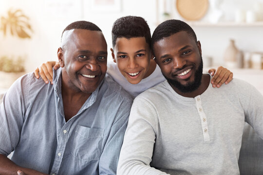 Joyful african son, dad and grandfather posing for family picture at home
