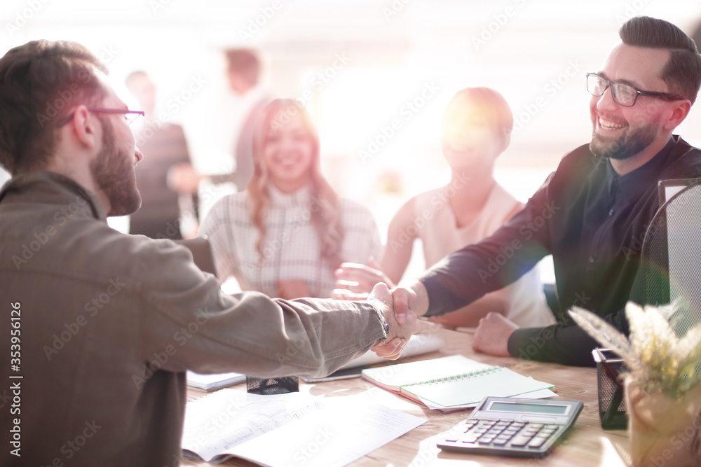 Poster smiling businessman at a working meeting in the office