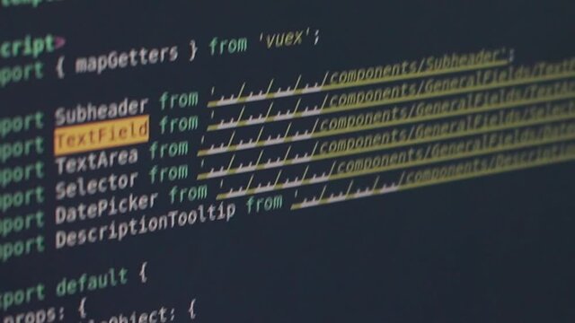 Black Computer screen of an engineer developing software app using Personal Computer and typing code on screen. Programmer coding internet security system for GPS tracker. Close-Up.