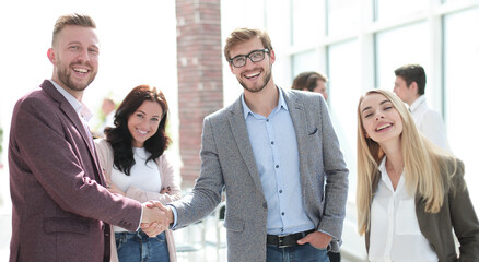 business partners shaking hands, greeting each other.