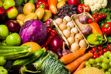 chicken eggs on the table with fresh vegetables from the garden