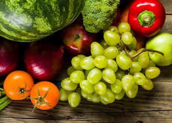 grown home-grown products from the garden, summer farm harvest of fresh vegetables on the table, grapes apples eggplant cucumbers zucchini potatoes salat leaves