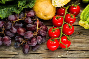assortment of different bright vegetables, garden home.potato grapes and cherries.