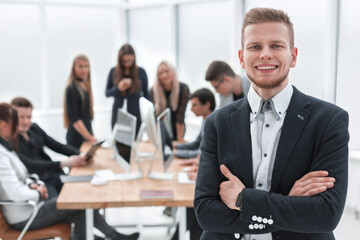 confident business man standing in the office