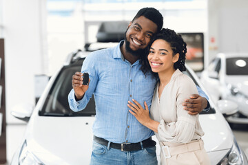 African Spouses Showing New Vehicle Key To Camera In Dealership