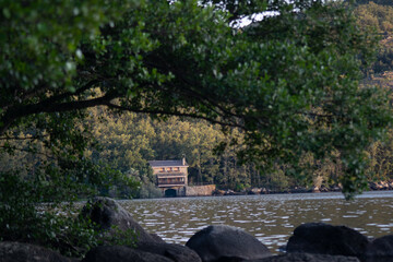 Fototapeta na wymiar mill house on the lake surrounded by forest