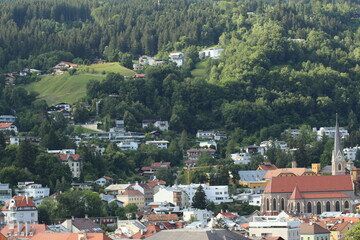Fototapeta premium Aerial view of Innsbruck city taken from City Tower (Stadtturm) which was built in 1450 in Tirol, Austria. With 51 meters of height, City Tower is located in Old City (Altstadt or Altestadt).