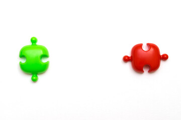 Red and green puzzles on a white background.Social distance concept to prevent the spread of coronavirus COVID-19.Flat lay, copy space for text