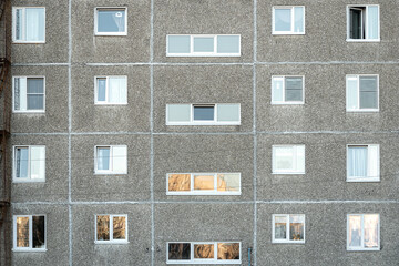 Facade of a grey multi-storey soviet panel building