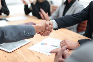 business partners greeting each other at the negotiating table