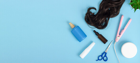 Hairdresser tools on blue background with copy space
