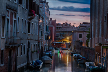 Fototapeta na wymiar fascinating water canal at dusk in Venice Italy