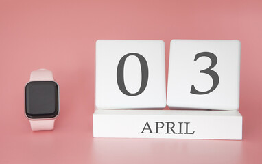 Modern Watch with cube calendar and date 03 april on pink background. Concept spring time vacation.