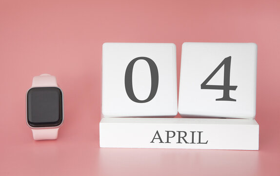 Modern Watch with cube calendar and date 04 april on pink background. Concept spring time vacation.