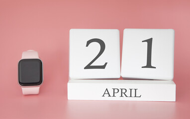 Modern Watch with cube calendar and date 21 april on pink background. Concept spring time vacation.