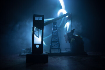 Stock market declining chart and oil pump jack - abstract background