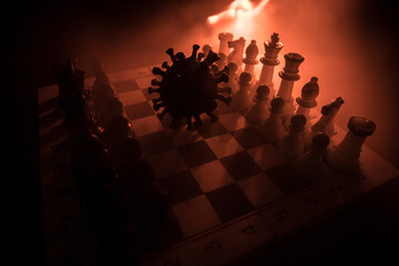 Big Corona virus miniature model on chessboard with fog and backlight. Creative artwork decoration. Selective focus