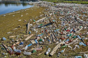 Plastic waste drifting in polluted water accumulated at a dam, environmental problems