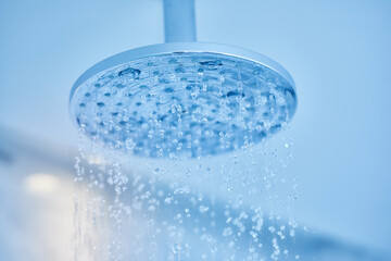 Shower turned on, ceiling shower head closeup