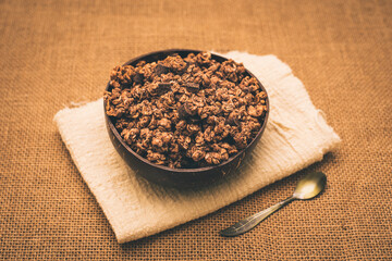A wooden bowl full of muesli for the snack of athletes who want to keep fit.