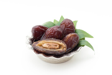 Palm dates on the silver plate, white background.