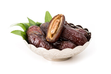 Palm dates on the silver plate, white background.