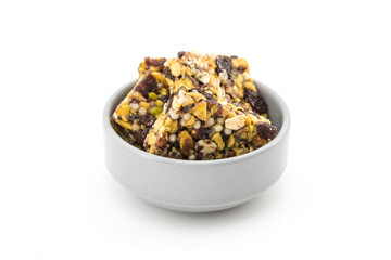Fruit, nut and seed bar with pistachios isolated on white.