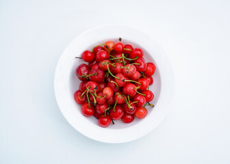 Fresh cherries in a white porcelain dish.