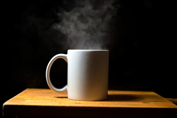 white cup on black background with wood and smoke