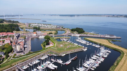 Obraz premium Aerial view of picturesque fortress town of Willemstad in the Netherlands, Brabant. With mill and ports. 