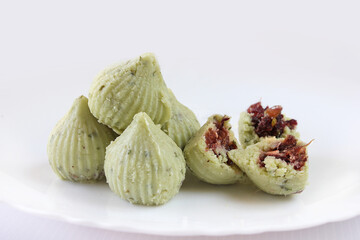 Modak [ladoo]or ladu is Indian traditional sweet dish made from khoya[mawa] with sugar and dryfruits during festival of lord Ganesha.