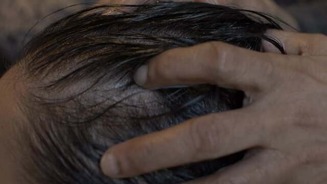 Young Asian Female Getting Oil Massaged Into Her Scalp And Hair. Locked Off, Side View , Close Up