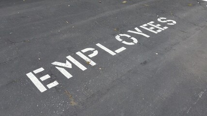 Signage of "Employee" on the pavement