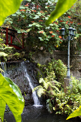 Waterfall, bridge, and street lamp.