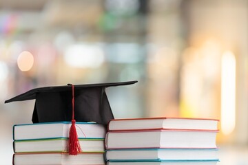 Graduation hat and stack of study books