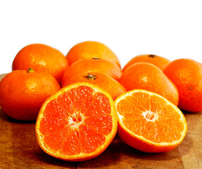 Oranges and one cut into halves sweet seedless oranges