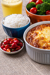 Escondidinho. Typical Brazilian food. Made from potatoes and chicken. .Accompanied by rice and salad