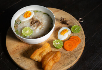 Asian congee with minced pork in white bowl.