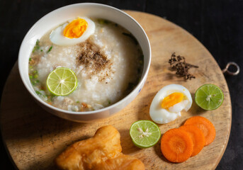 Asian congee with minced pork in white bowl.